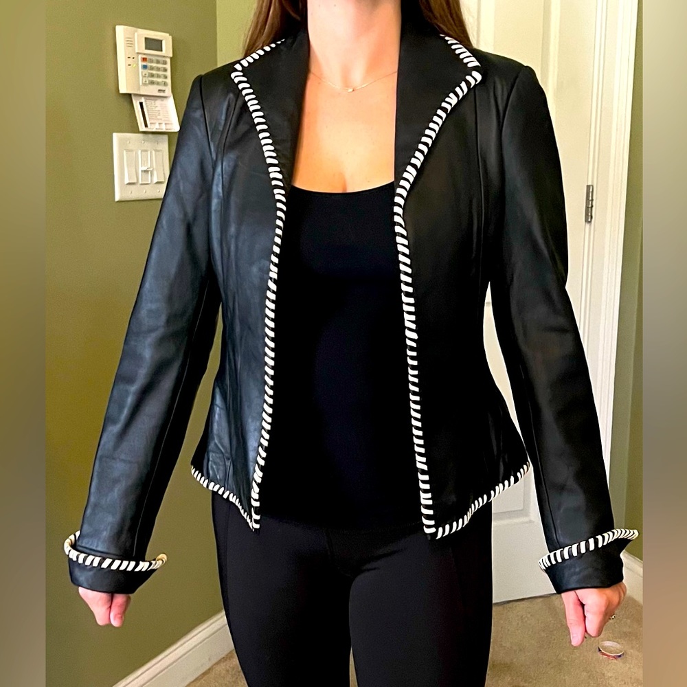 100% black leather jacket with white trim